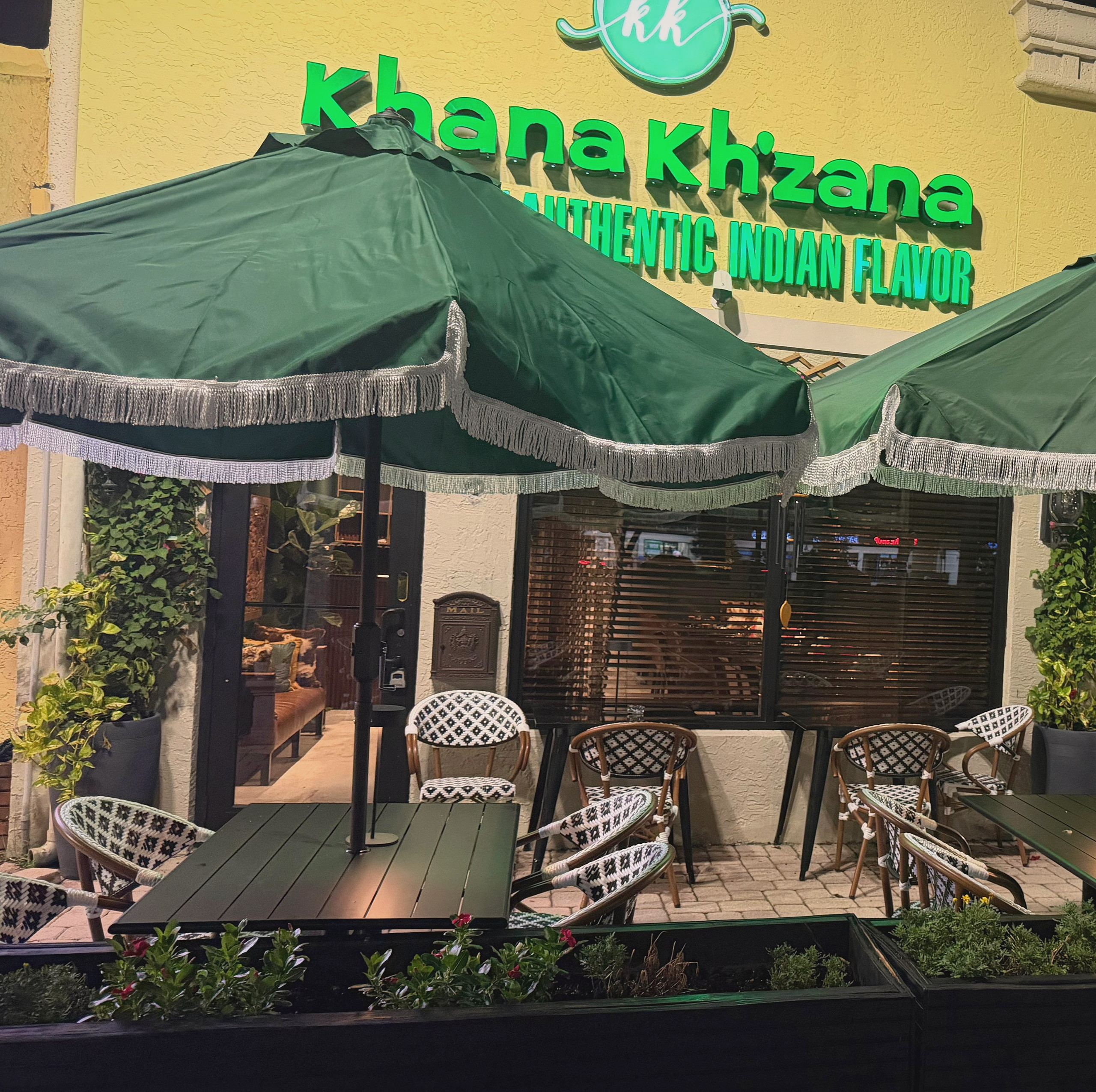 The khana kh'zana storefront at night on Sample Road in Coral Springs