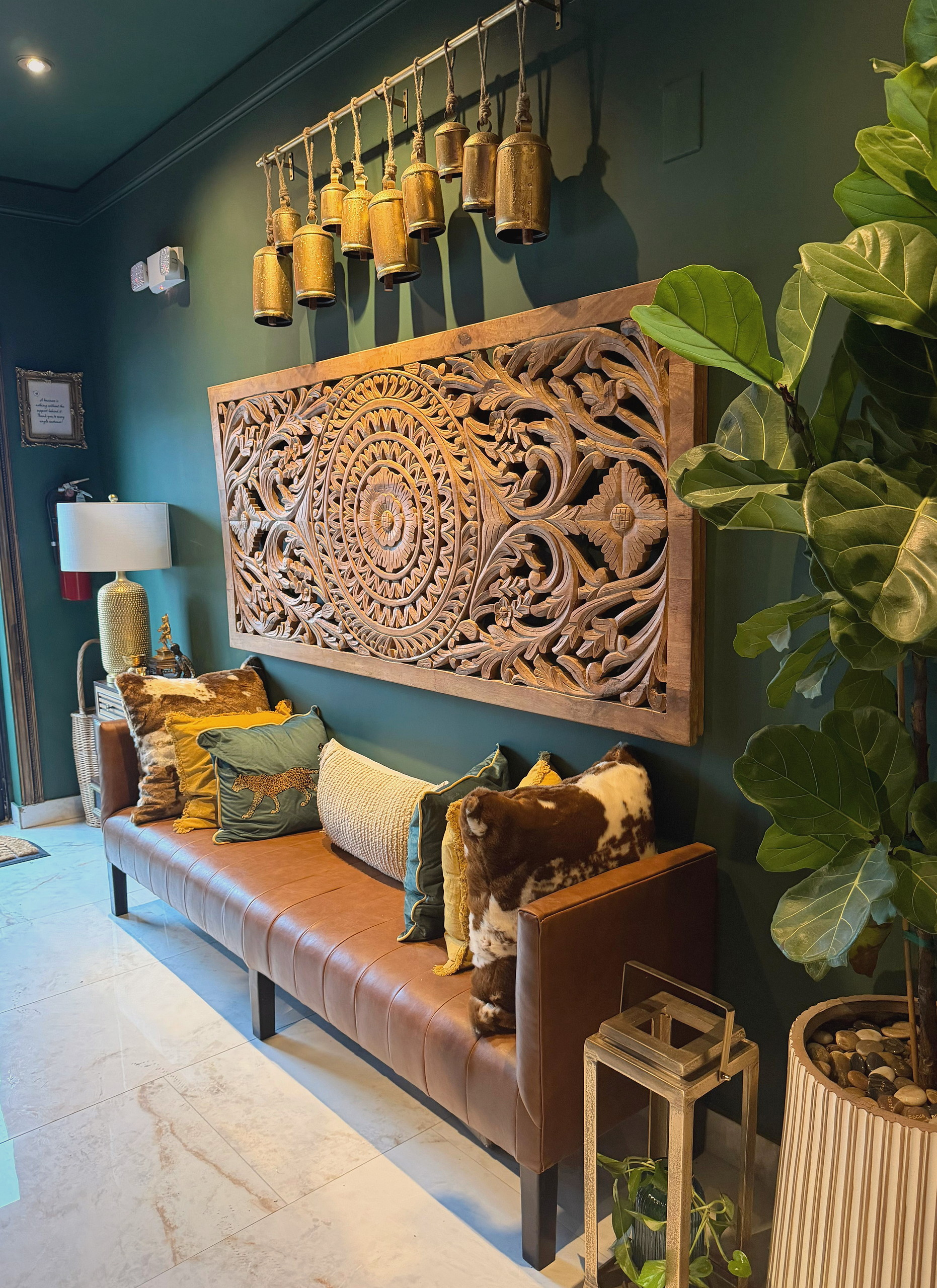The waiting nook: carved wood, brass bells and cognac leather